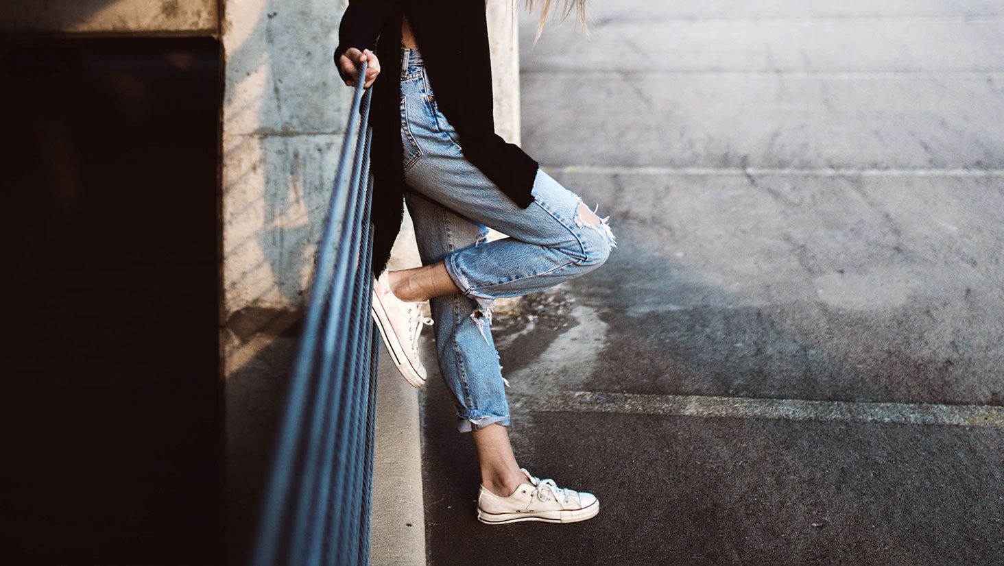 Person Standing with Foot on Rail